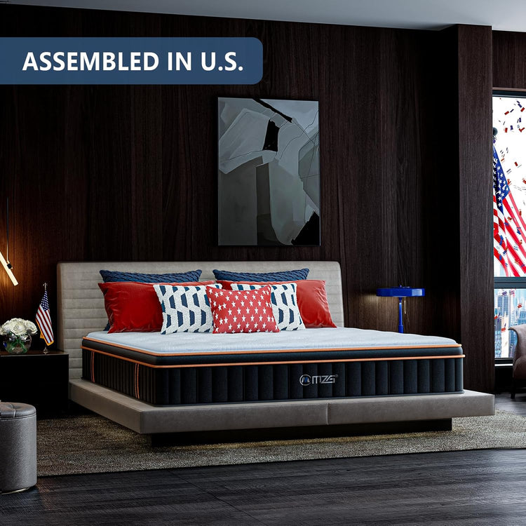 Mattress in a bedroom setting with decorative pillows and an American flag.