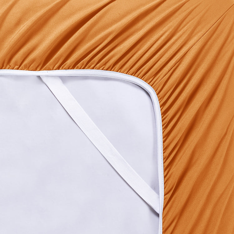 Close-up of a fitted sheet being pulled over a mattress corner with a plain background.