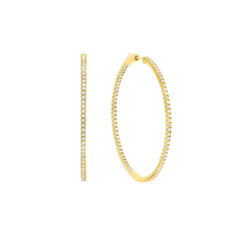 Gold hoop earrings with embedded diamonds on a white background