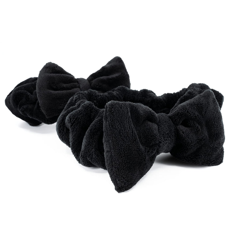 Set of black scrunchies on a white background