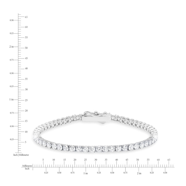 Silver bracelet with clear stones on a white background with measurement scale
