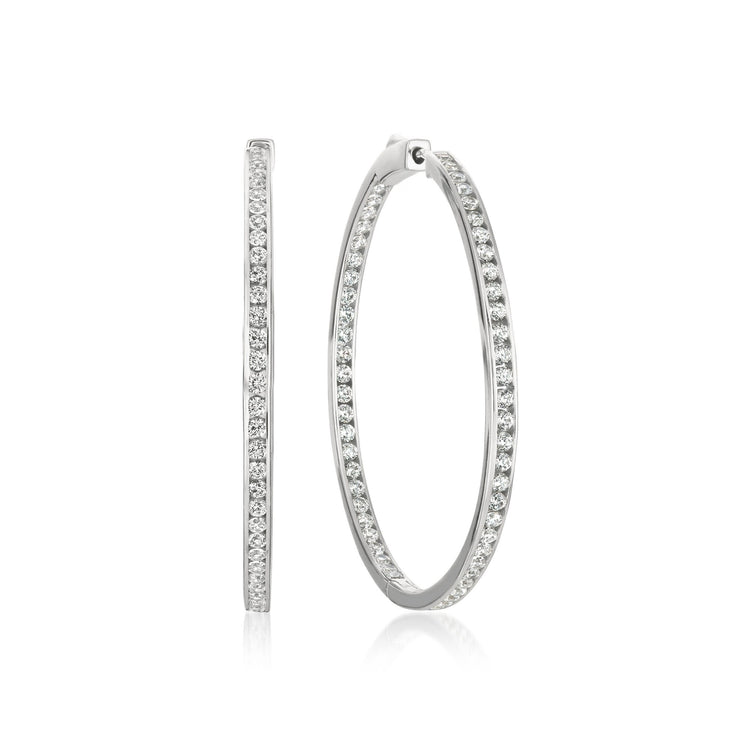 Pair of silver hoop earrings with embedded stones on a white background