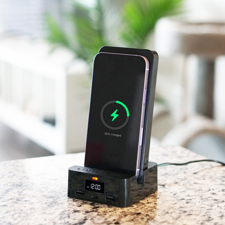 Wireless charging station with smartphone displaying charging progress on a blurred background