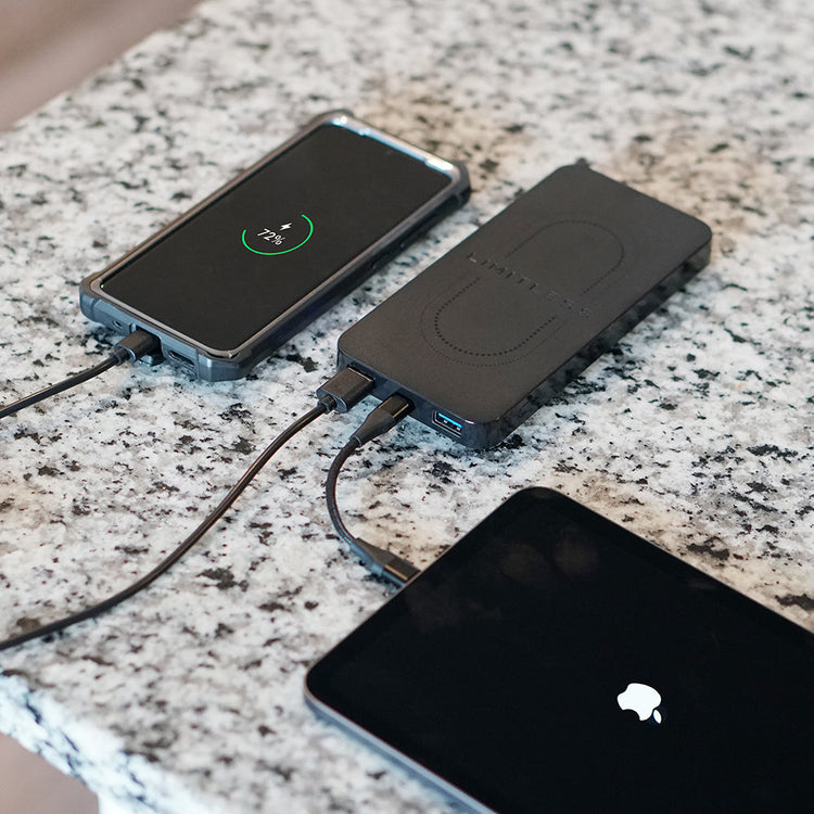 Two wireless chargers on a granite countertop with one charging a smartphone.