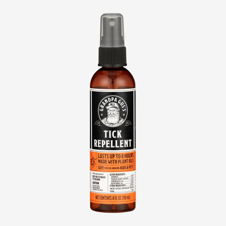 Tick repellent spray bottle with label on a white background