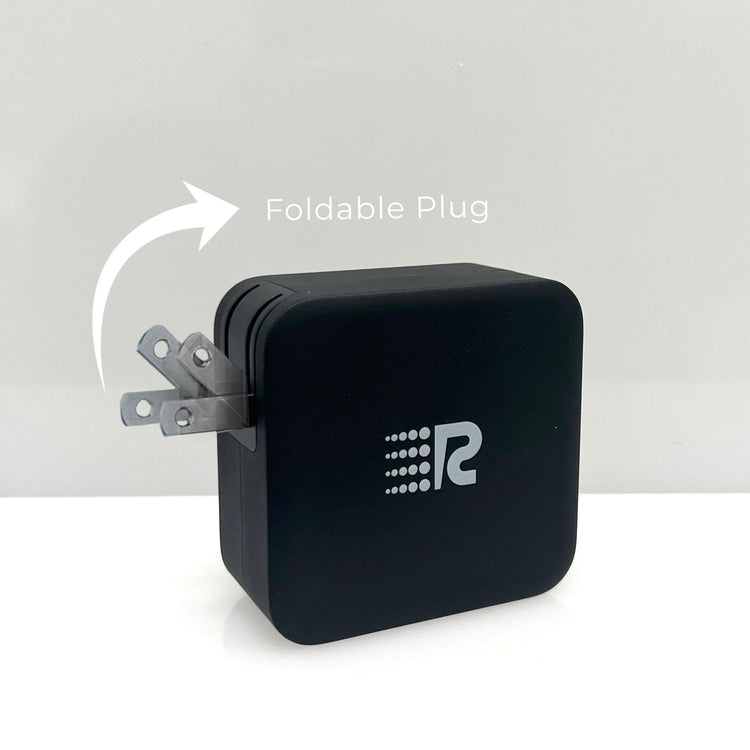 Black power adapter with foldable plug on a white background