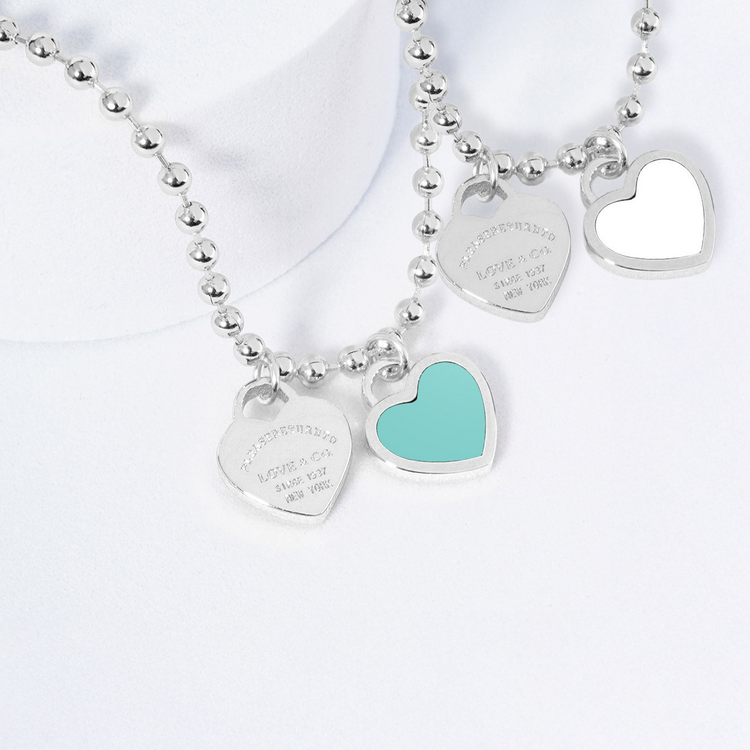 Silver necklaces with heart-shaped pendants on a white background
