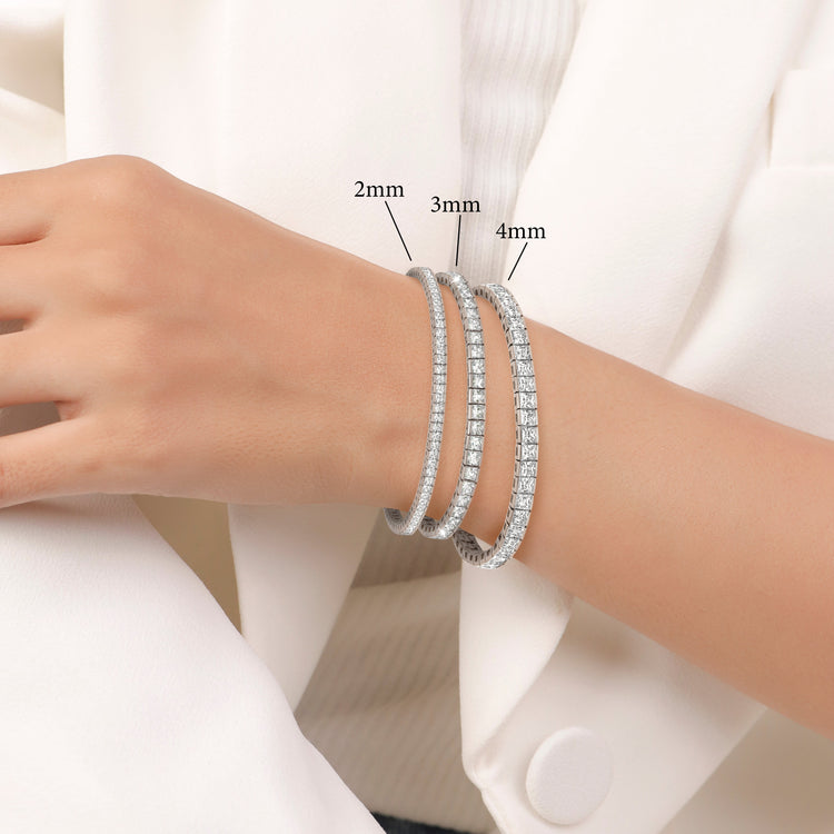 Silver beaded bracelets on a wrist with size labels