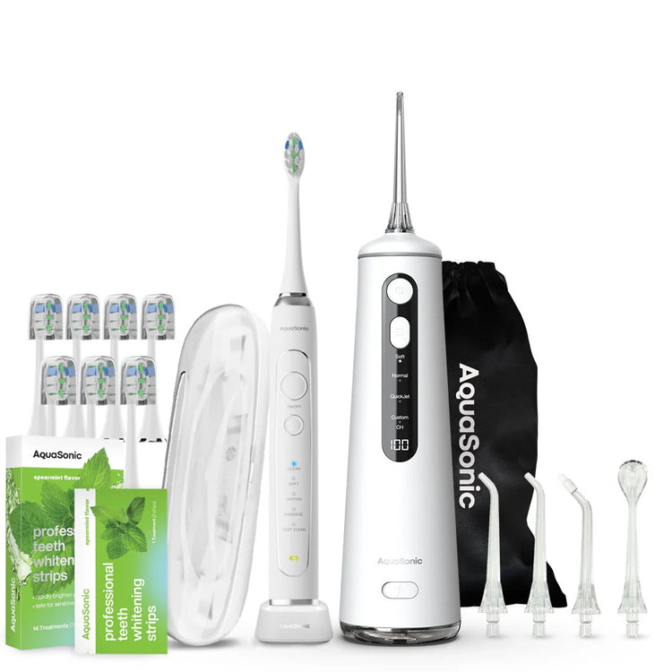 Aquasonic dental care product set including a toothbrush, water flosser, and accessories on a white background.