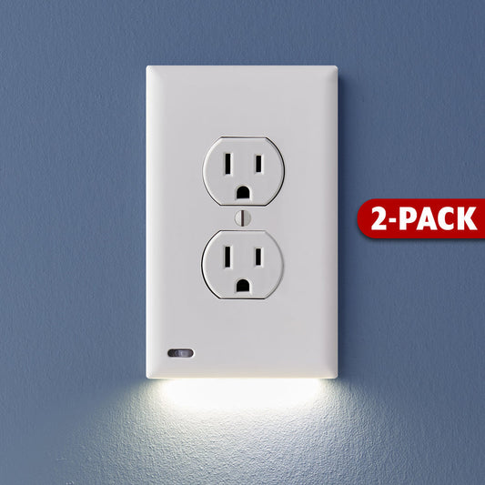 A white 2-pack of GuideLight outlet cover plates with built-in LED lights, mounted on a blue wall with the outlets visible at the bottom.