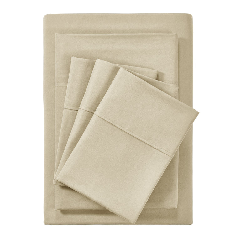 Beige bed sheets and pillowcases set on a white background