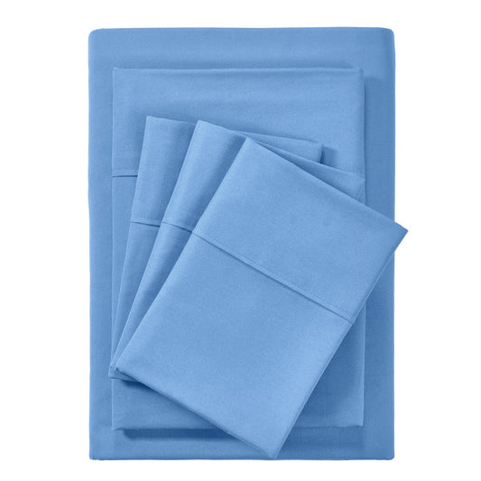A set of ocean blue bamboo sheets displayed on a bed, including a fitted sheet, a flat sheet, and pillowcases.