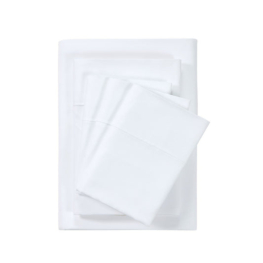 A white 6-piece bamboo sheet set on a bed, including a fitted sheet, flat sheet, and pillowcases, presented in a bright room setting with decorative plants and a nightstand.