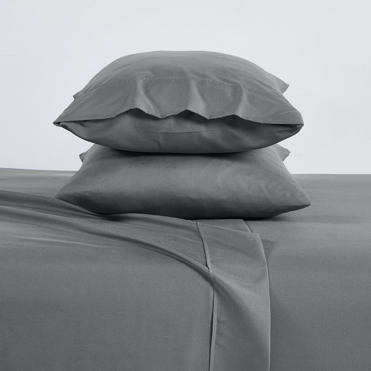 Gray bedding set with two pillows on a plain background
