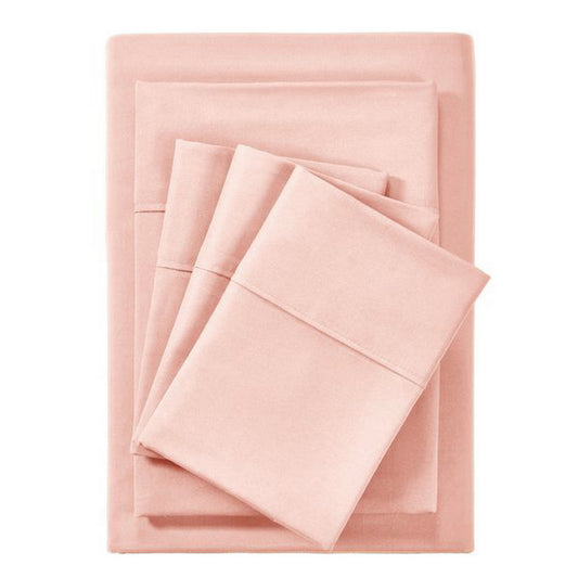 Pink bedding set on a bed with matching pillows in a bedroom setting.