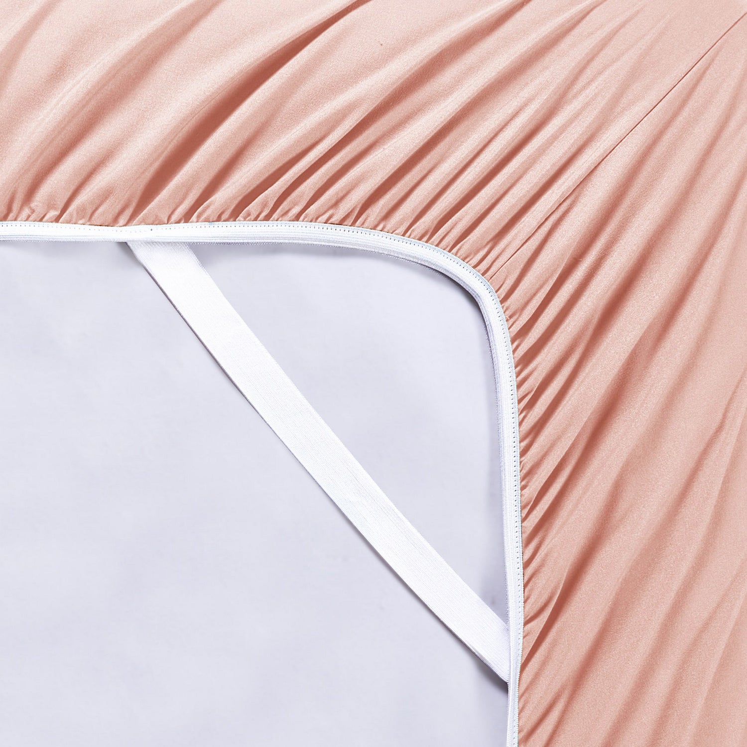 Close-up of a fitted sheet being stretched over a mattress corner.