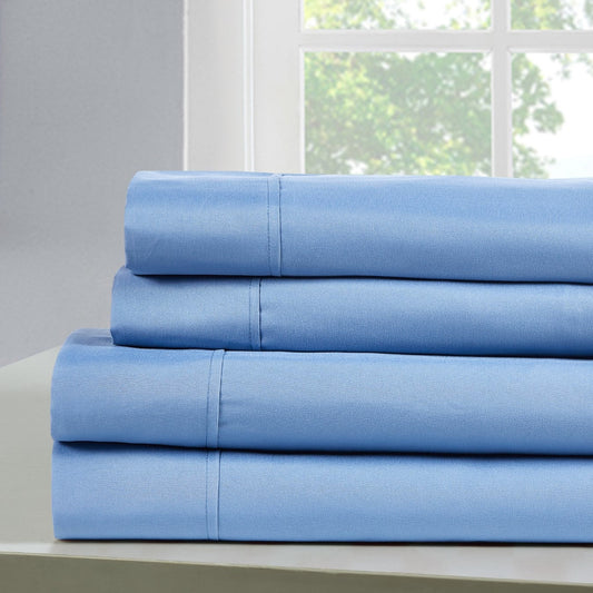 A set of ocean blue bamboo sheets displayed on a bed, including a fitted sheet, a flat sheet, and pillowcases.