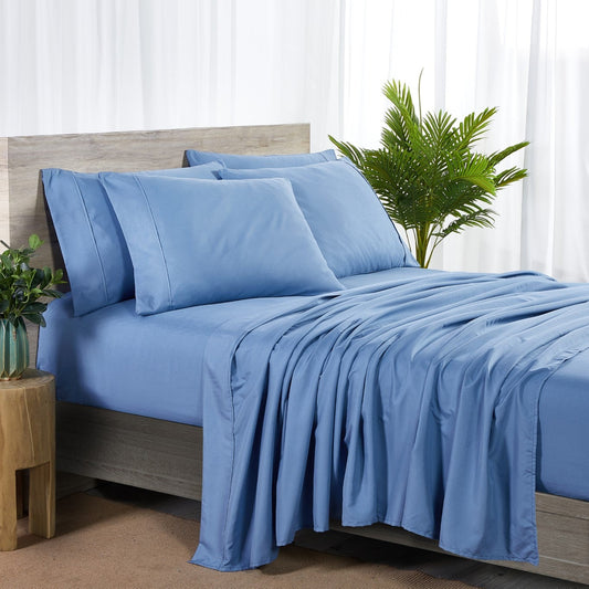 A set of ocean blue bamboo sheets displayed on a bed, including a fitted sheet, a flat sheet, and pillowcases.