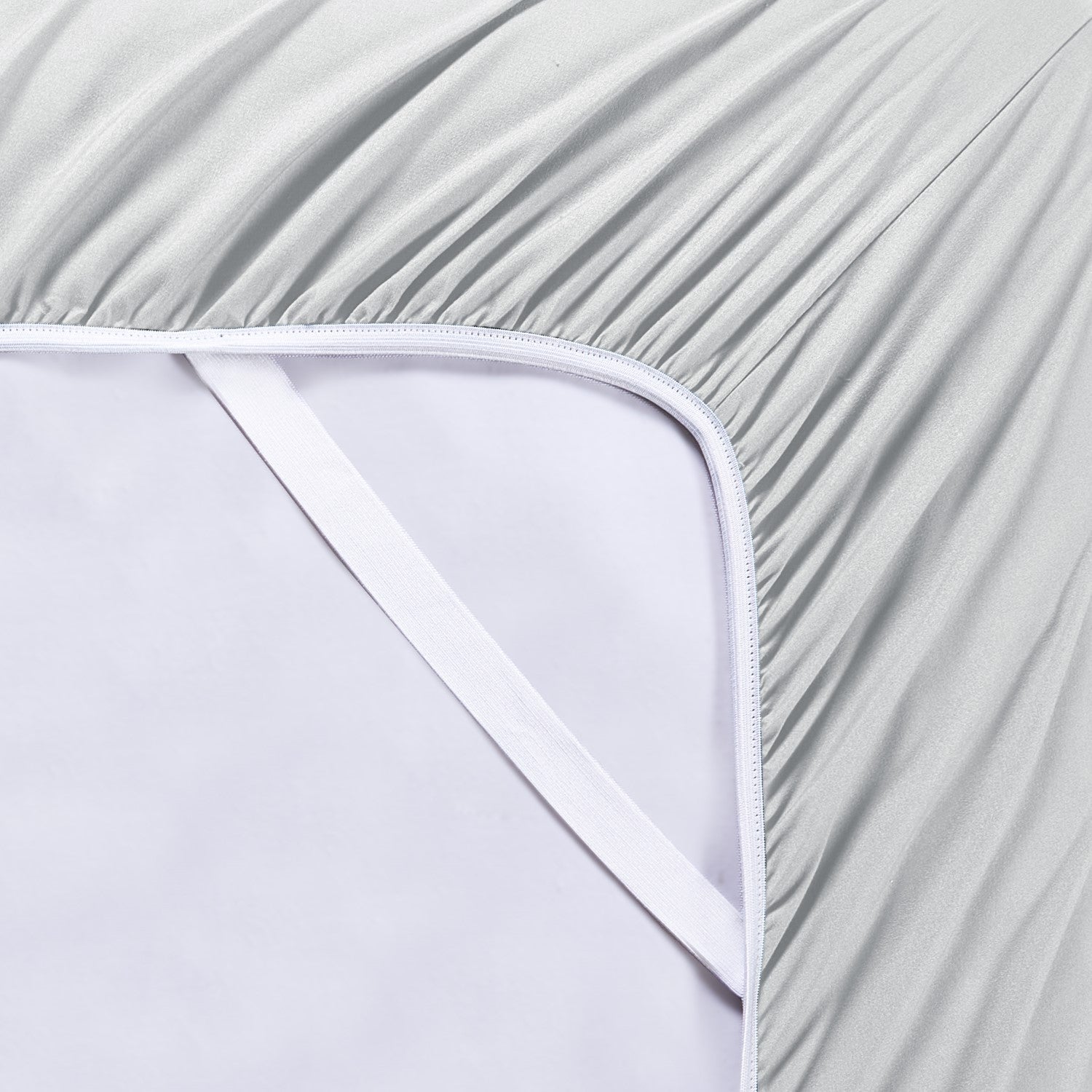 Close-up of a fitted sheet with a subtle pattern on a white background