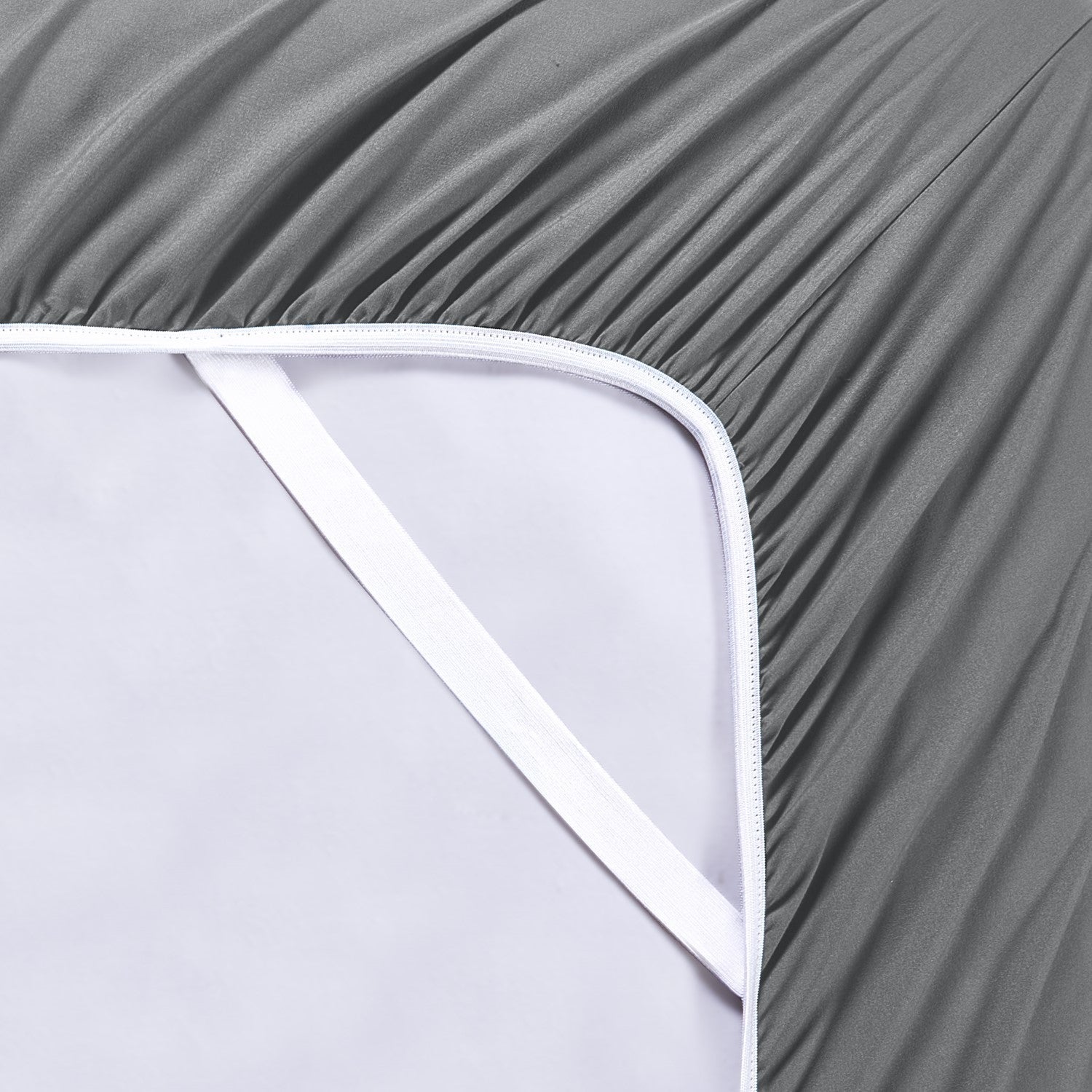 Gray fitted sheet on a white mattress
