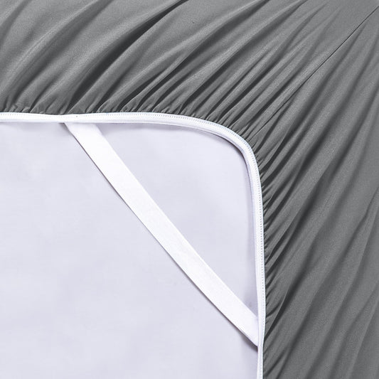 A charcoal grey 6 piece bamboo sheet set displayed on a bed, including a fitted sheet, a flat sheet, and pillow covers with a second pillow placed on the bed.