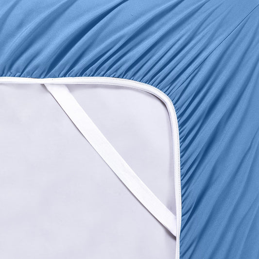 A set of ocean blue bamboo sheets displayed on a bed, including a fitted sheet, a flat sheet, and pillowcases.