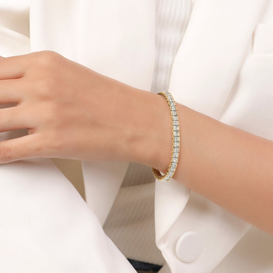 Gold bracelet with diamond accents on a white background