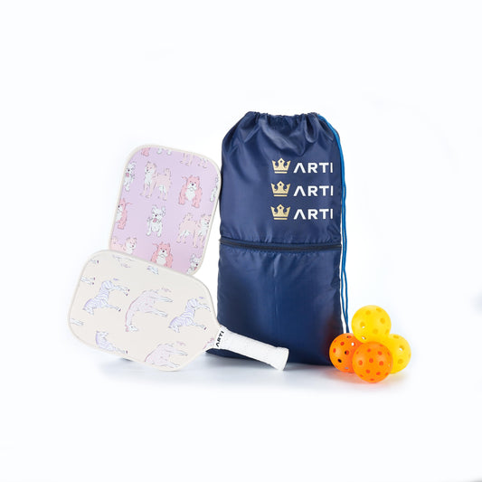 Pickleball paddles with colorful designs, a blue drawstring bag, and orange pickleballs on a white background.