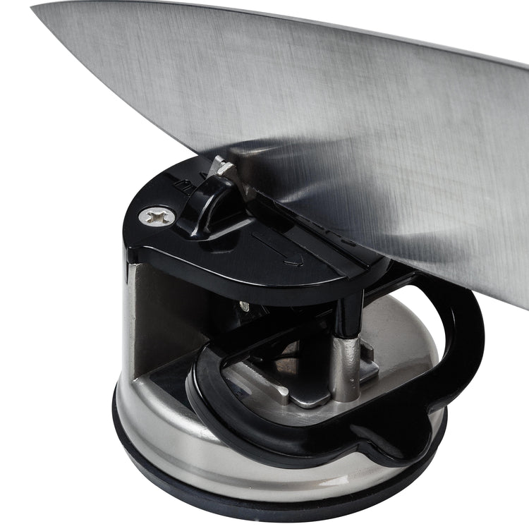 Knife sharpener with a knife being sharpened on a white background