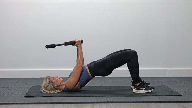Person exercising on a mat with a resistance band in a home setting