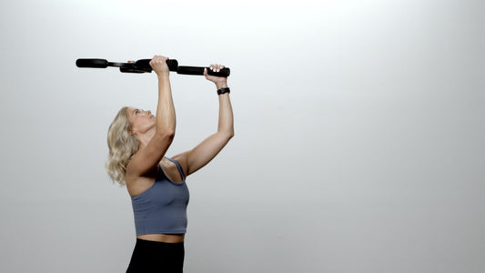 Black and red cross trainer on a gray background