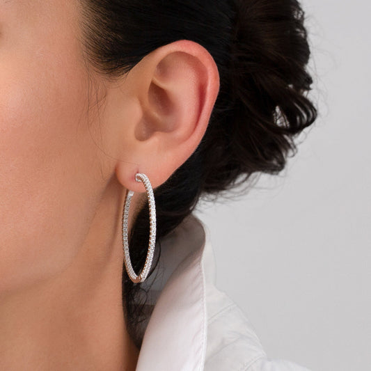 Silver hoop earrings on a white background