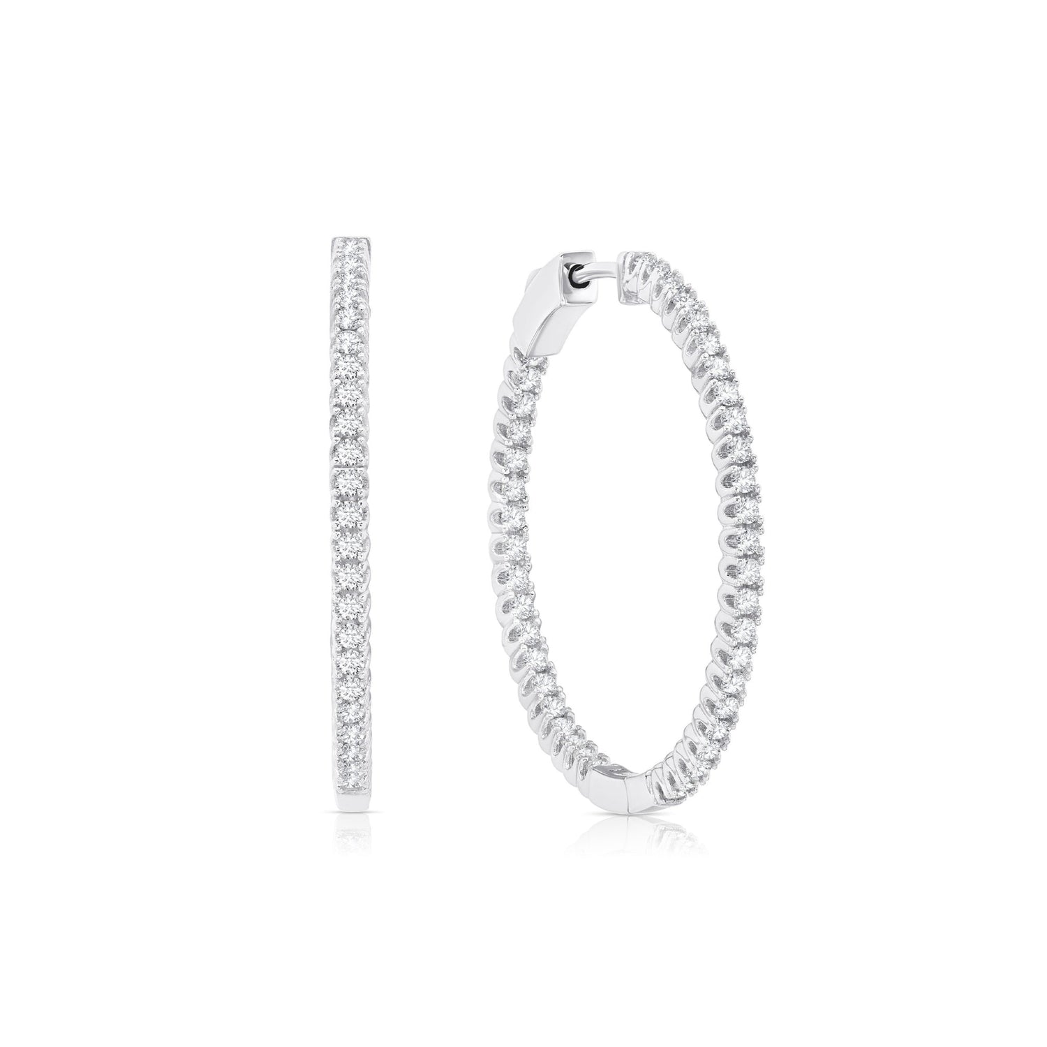 Silver hoop earrings with clear gemstones on a white background