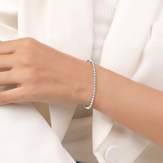 Silver bracelet with clear stones on a white background