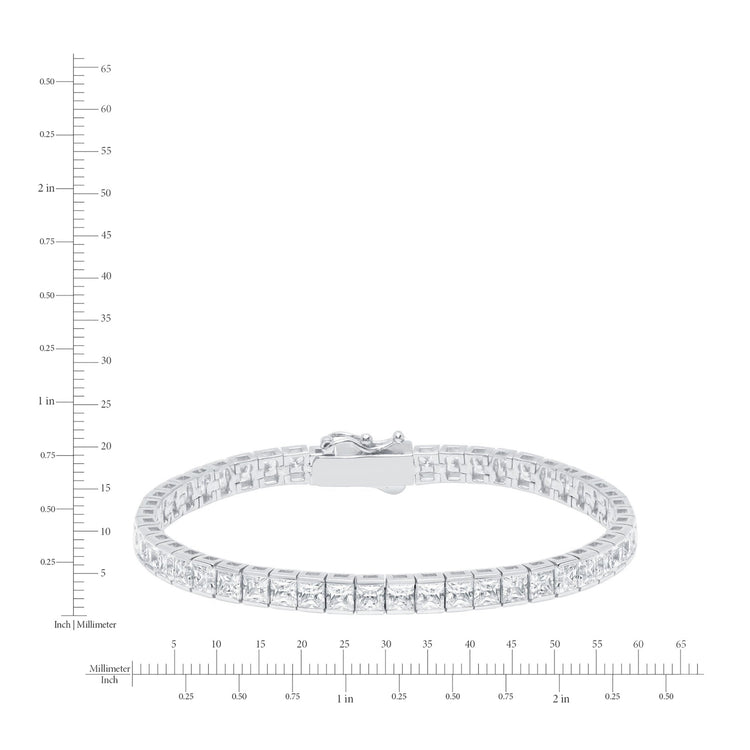 Silver bracelet with clear stones on a white background with measurement scale