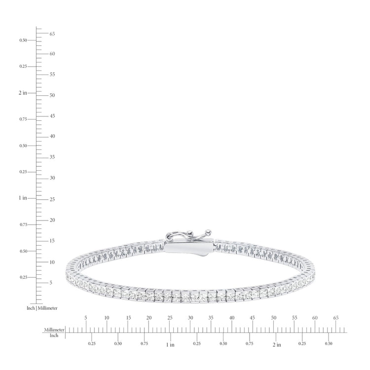 Silver bracelet with clear stones on a white background with measurement scale