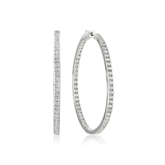 Pair of silver hoop earrings with embedded stones on a white background