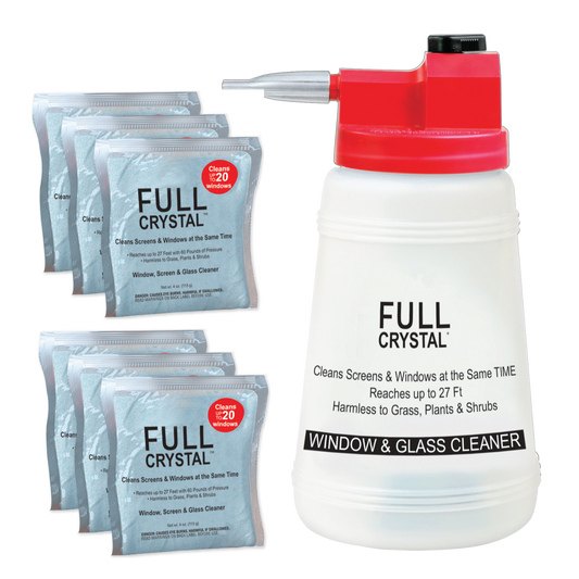 Person washing a house with a hose on a clear day