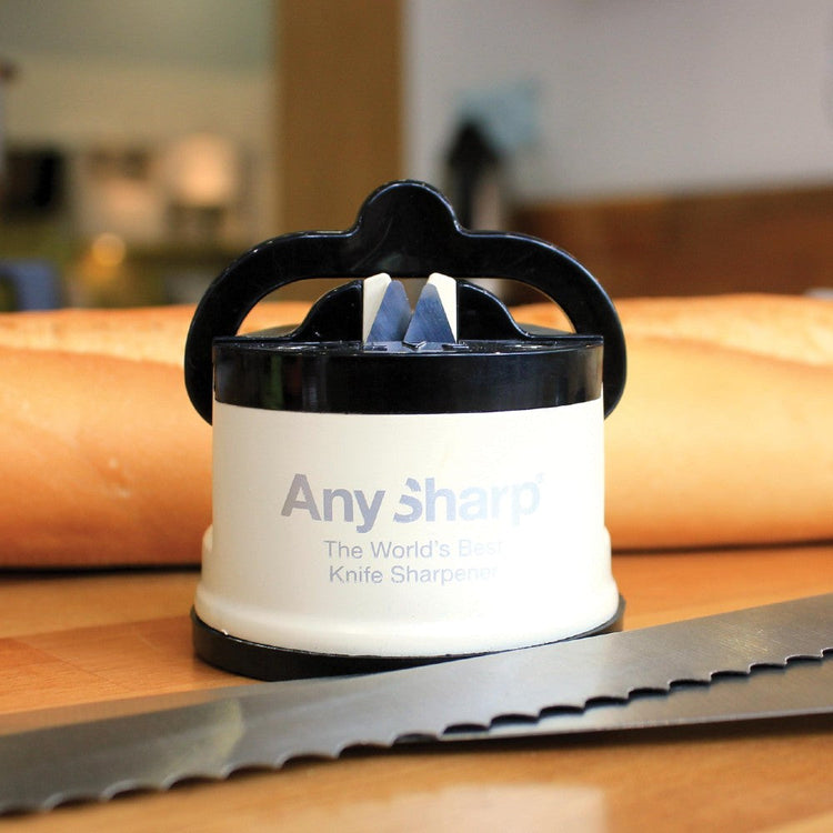 AnySharp knife sharpener on a wooden surface with a blurred background