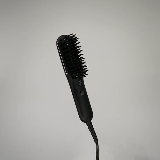 Black styling brush with LED indicator and packaging labeled 'brocchi' on a white background