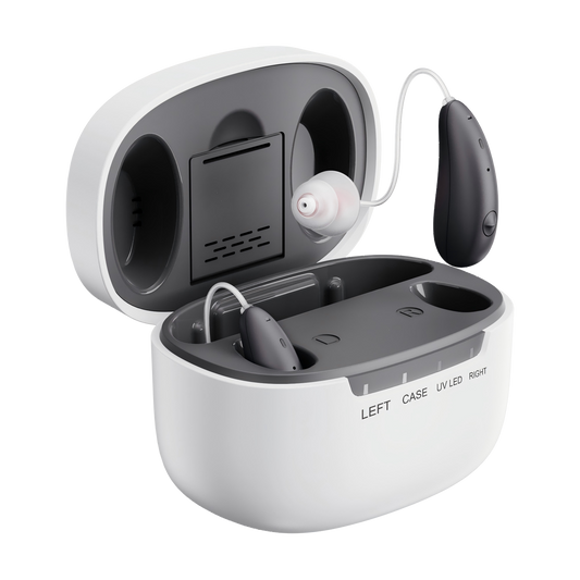 A pair of behind-the-ear hearing aids with a charging case, shown open on a clean white background. One hearing aid is inserted into the left ear canal opening, and the other is shown detached on a wire loop.