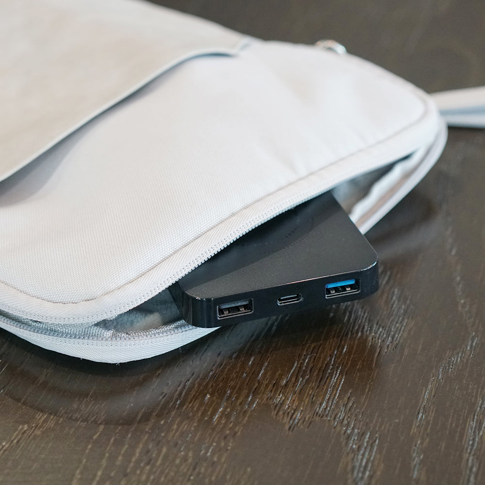 Black electronic device with multiple ports on a beige fabric surface