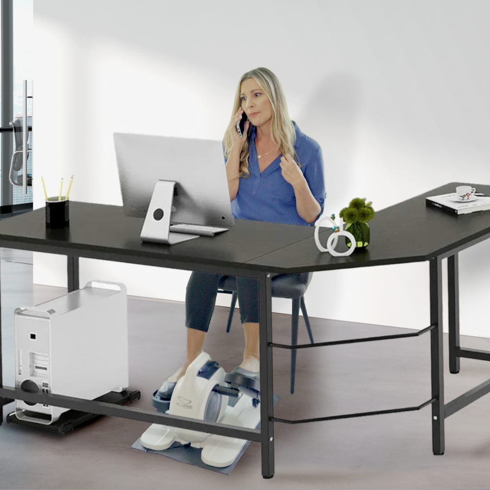 Woman sitting at a modern office desk using a phone, with a white background