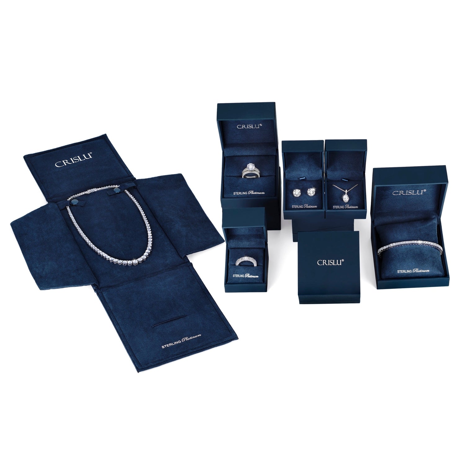 Collection of Crislu jewelry in open boxes on a white background