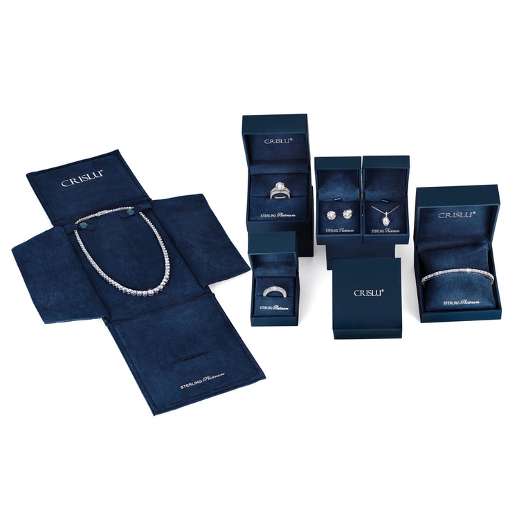 Collection of Crislu jewelry in open boxes on a white background