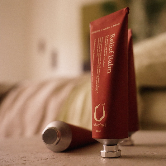 Brown tube of 'Relief Balm' by Wholistic on a white background