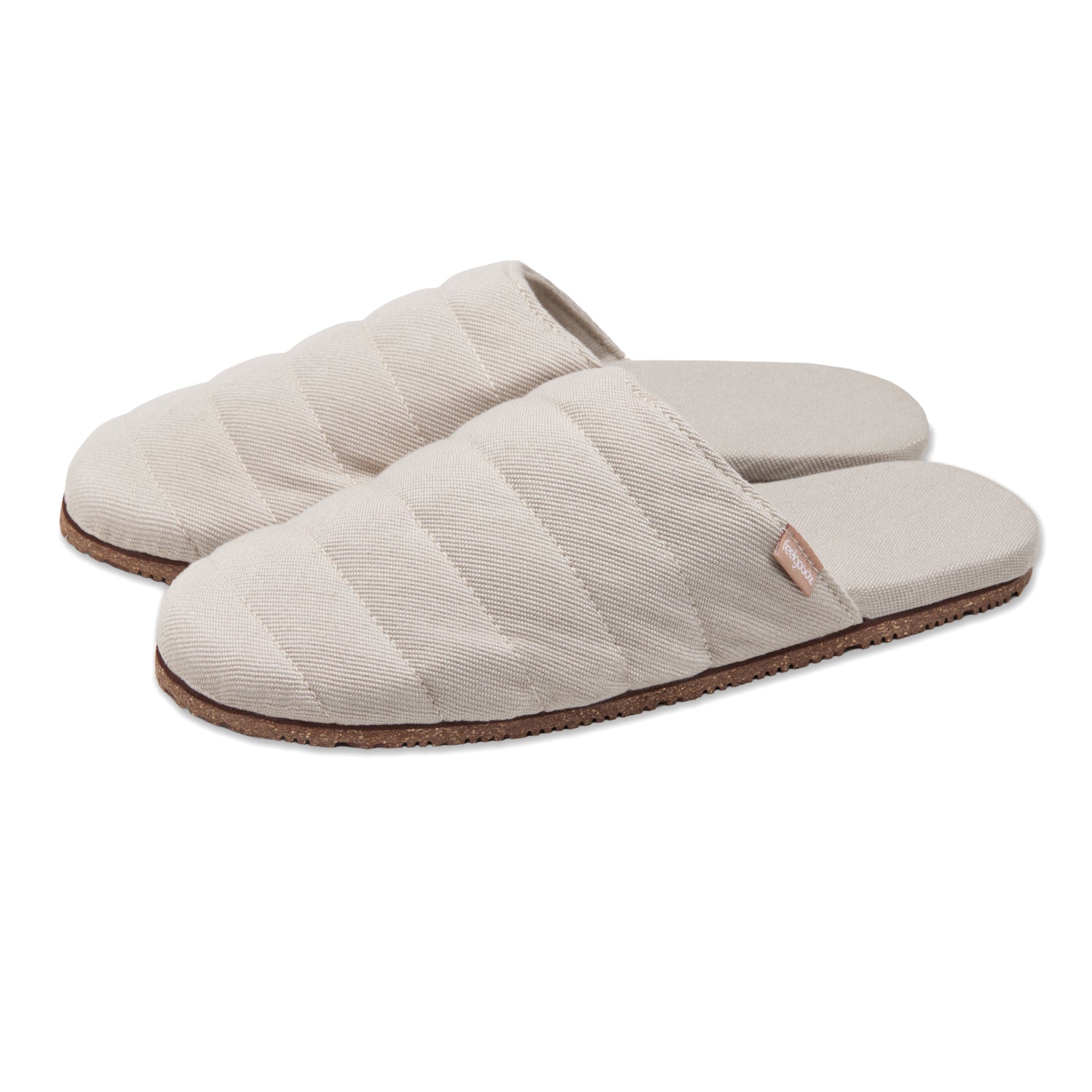 Pair of beige quilted slippers on a white background