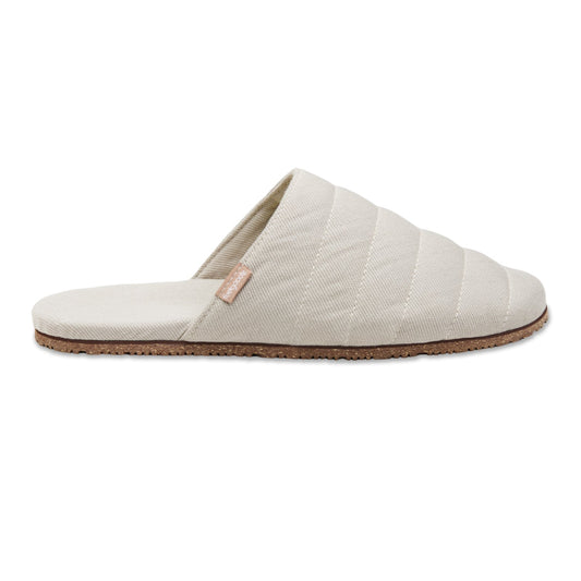 Pair of beige quilted slippers on a white background