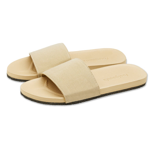 Beige slide sandals with a brand logo on a white background