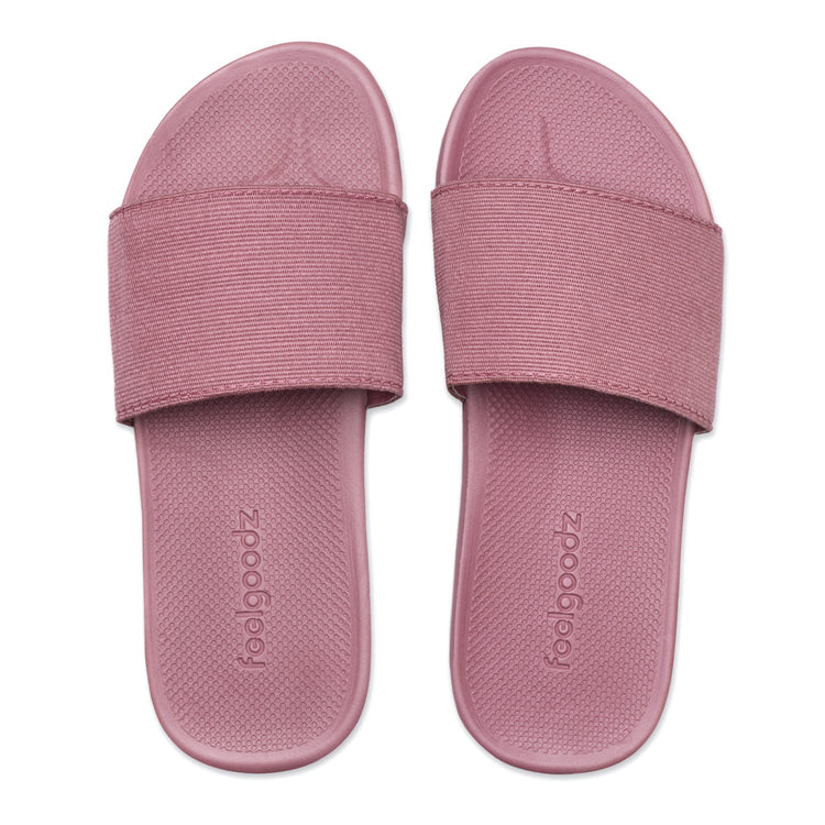 Pair of pink slides with 'foolgoodz' branding on a white background